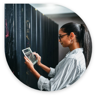 woman looking at an iPad in a data center