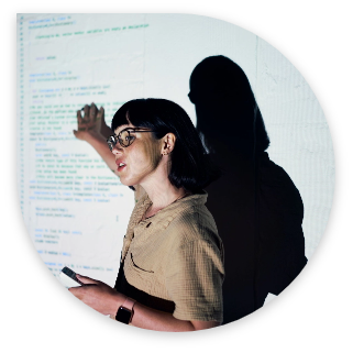 woman presenting in front of a screen projection